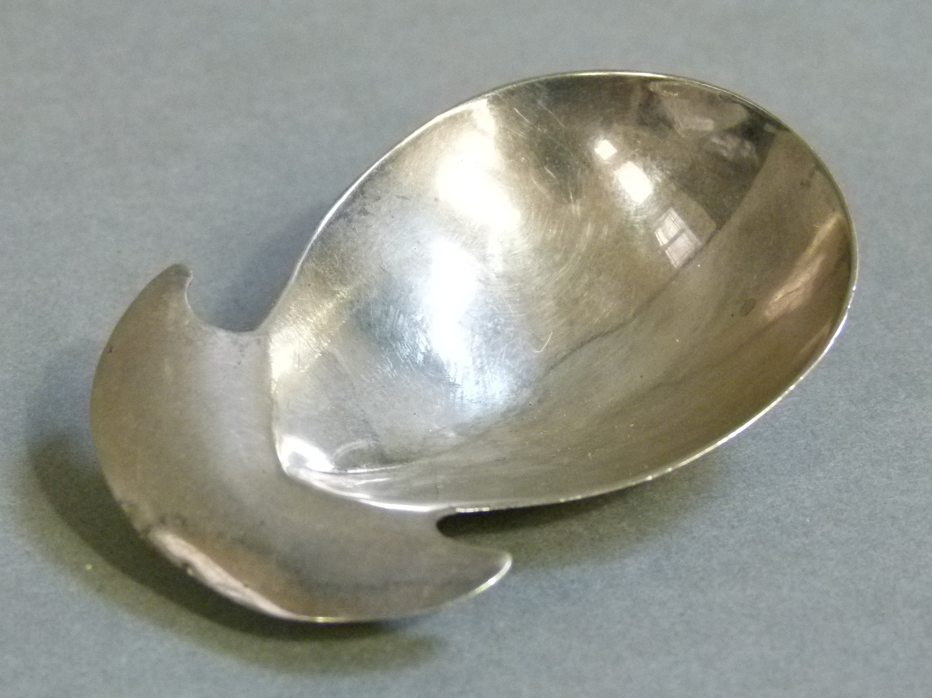A George III silver caddy spoon of fig shape with crescent handle, 6cm wide by Hester Bateman or