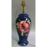 A Moorcroft blue anemone table lamp slip trail decorated with flower heads in shaded purple and