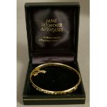 A diamond set stiff hinged bangle in 9ct gold by Goldsmiths Ltd, Limited Edition 164/200, the