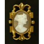 A Victorian shell cameo brooch in a pinchbeck mount, the oval classical female portrait with dressed