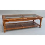A reproduction coffee table of shaped rectangular outline inset with two bevelled glass panels above