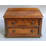 A Victorian mahogany two drawer small chest with rear upstand, rounded front corners above two