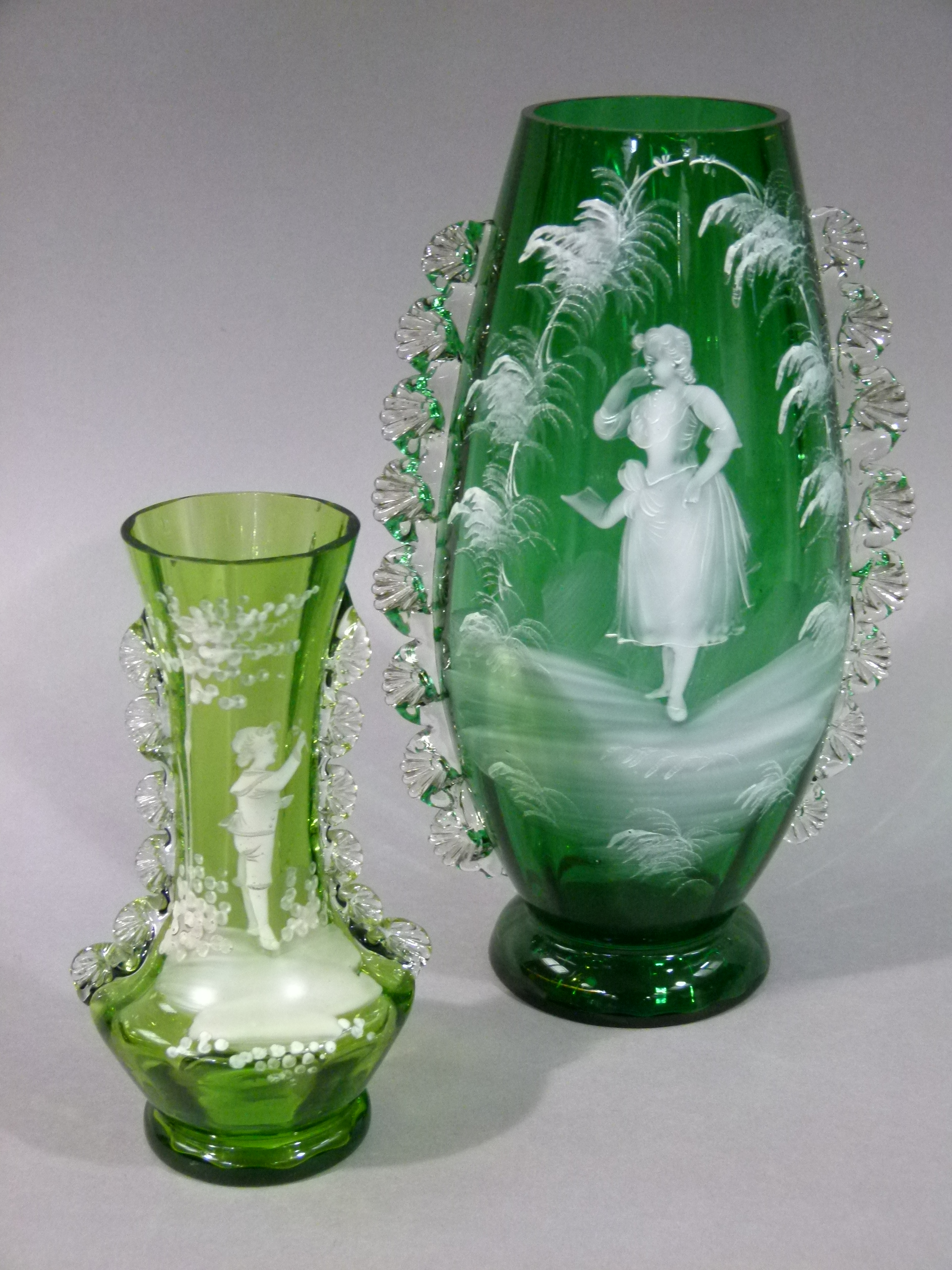 A Victorian Mary Gregory style green glass baluster vase with crimped clear glass handles, 27cm