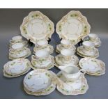 A Colclough china tea service printed in brown with floral sprays and enamelled in yellow and