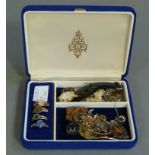 A small collection of costume jewellery including, dress rings, a small watch, chains, badges,