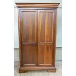 A reproduction fruitwood two door wardrobe