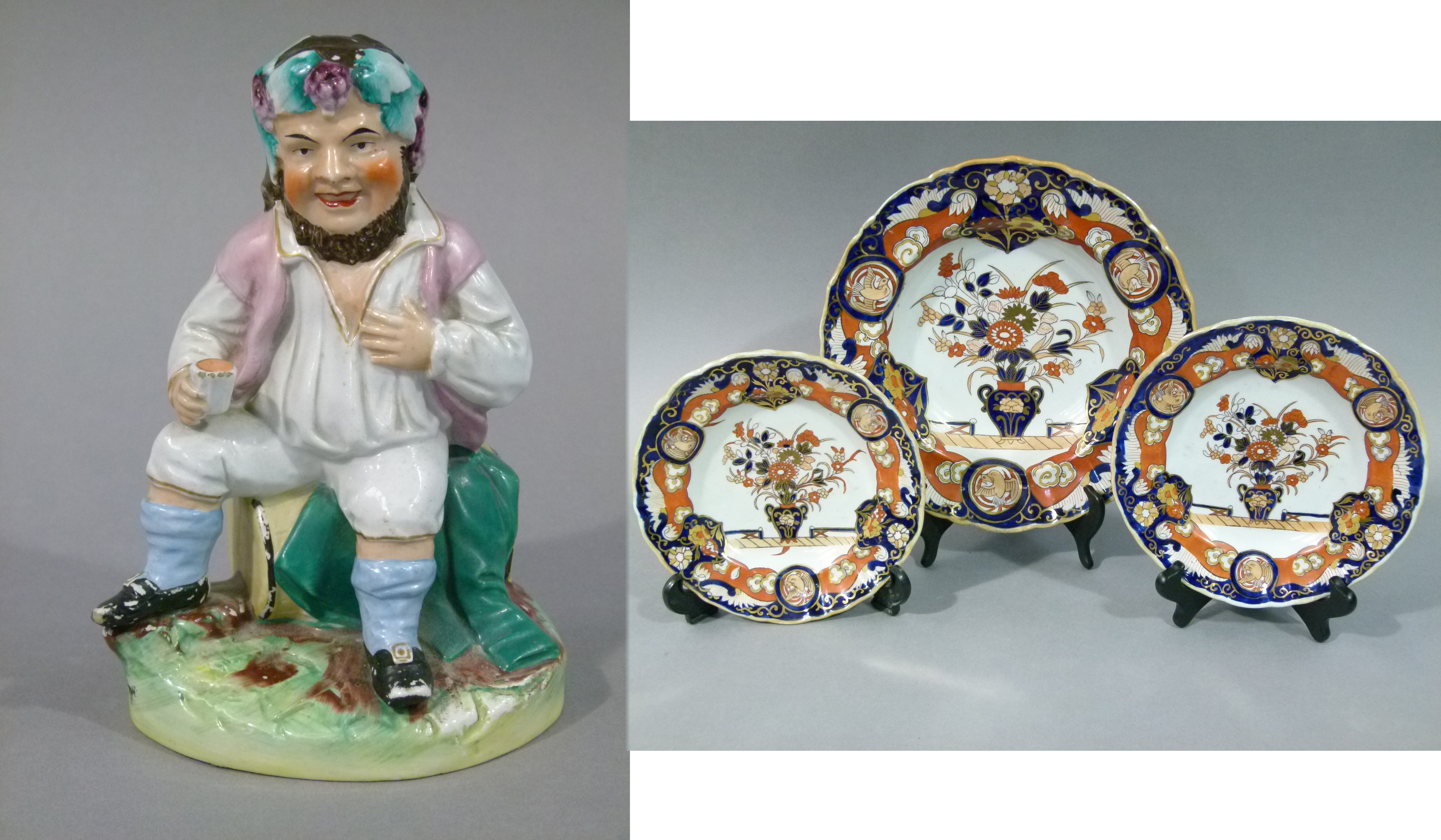 A Victorian staffordshire flat back figure of a seated gnome with grapes and leaves in his hair,
