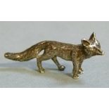 A cast silver model of a fox, realistically modeled, 5cm long by L J Millington, Birmingham 2009