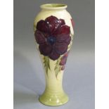 A Moorcroft yellow anemone vase slip trail decorated with open anemones in shaded purple, green