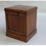 A mahogany perdonium of rectangular outline drop down paneled front and skirted plinth, 36cm wide