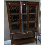 A Edwardian inlaid display cabinet with bowed glass center section, on square legs with undertier