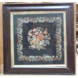 A Victorian needlework panel of petit and gros point depicting a young woman and her suitor in a