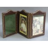 A triple fold leather and gilt tooled photograph frame of arched rectangular outline