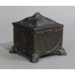 A French Art Nouveau pewter casket of square outline the interior lined in silk, the domed cover and