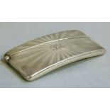 An Edward VII silver card case of concave rectangular form engine turned radiating bands surrounding