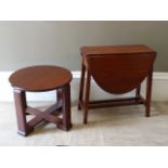 A mahogany Pembroke table having twin oval dropped leaves on square framing together with an Art