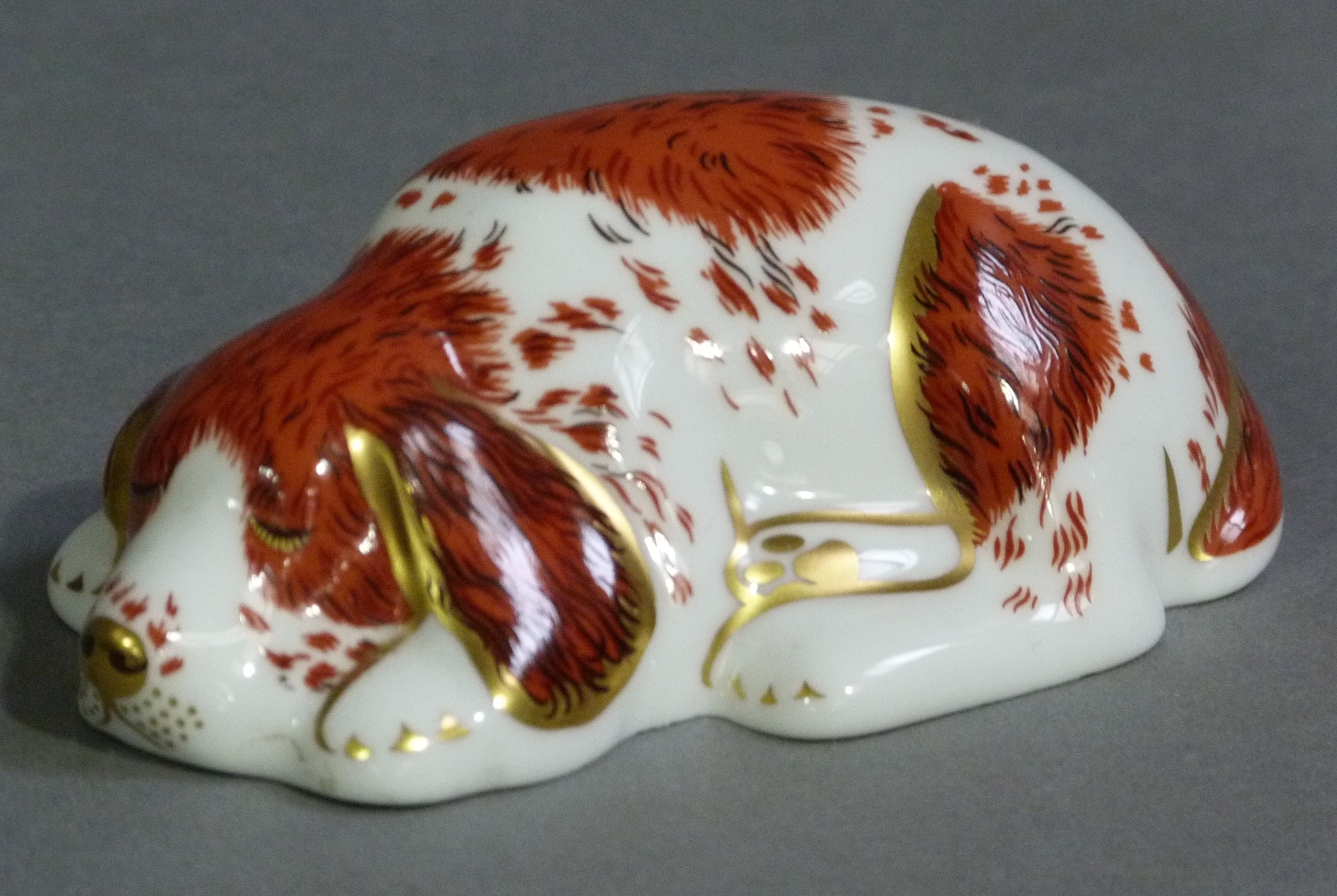 A Royal Doulton paperweight puppy exclusive Royal Crown Derby collectors guild with gilt button