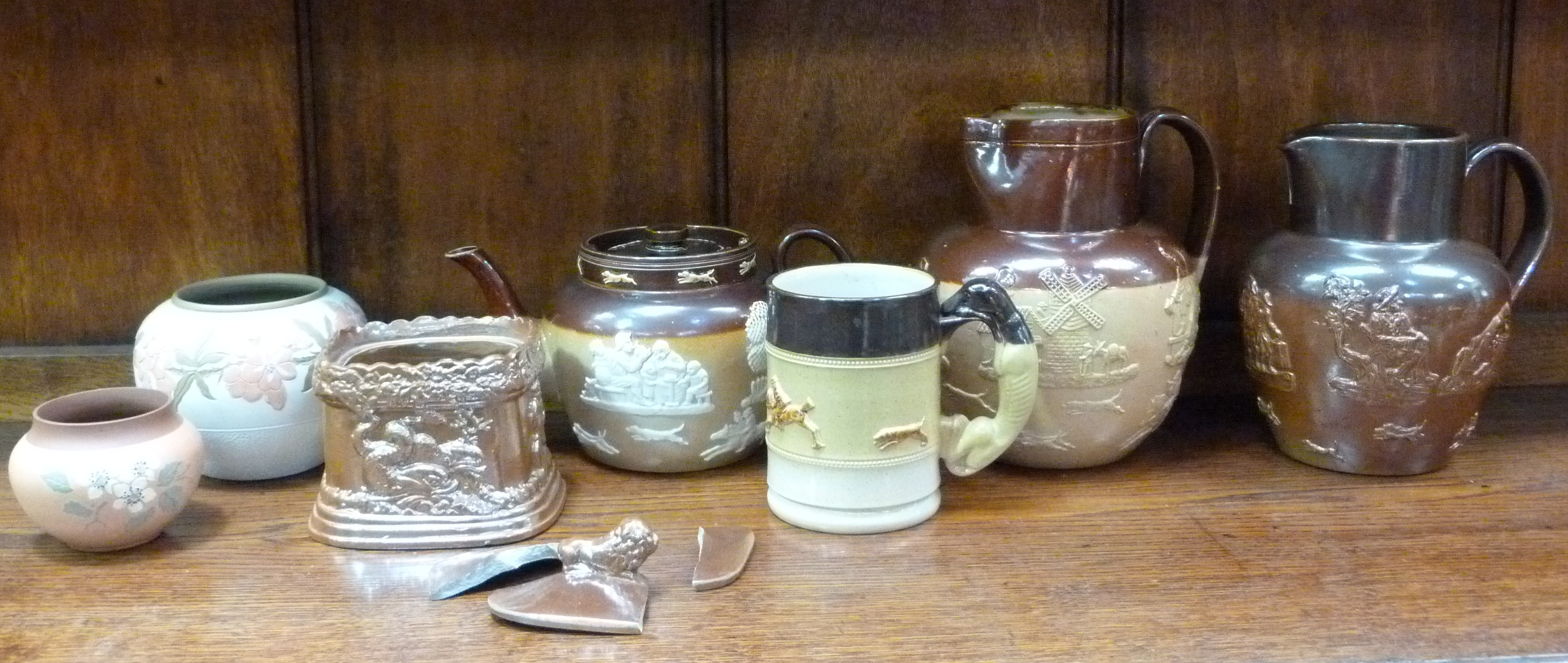 A Doulton Lambeth salt glazed jug, the upper section treacle brown, the lower section beige relief - Image 2 of 2