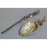 A continental caddy spoon cast with pair of lovers and dog, stylized cast dolphin handle, 9.5cm long