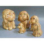 A set of five graduated Crown Devon dogs each with a streaky yellow brown glaze, glass eyes, 23cm