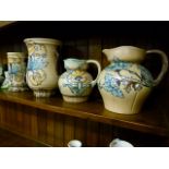 Five pieces of Crown Devon Art Deco pottery, moulded with Hollyhocks and summer flowers including