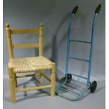 A child's rail back rush seat chair together with a child's sack trolley