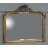 A reproduction gilt plaster wall mirror in George III style with arched bevelled plate, 134cm wide x