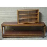 A rosewood effect folding two tier trolley; together with a small teak effect book case with sliding