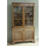 A George III style mahogany bookcase with astragal glazed upper doors the base with panelled