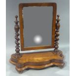 A Victorian mahogany dressing table mirror, the arched rectangular plate supported on a pair of