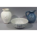 A reproduction blue glazed pottery jug together with a matching cream glazed baluster vase and a