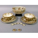 A pair of Japanese pottery cups and saucers, Meiji period, painted in gilt iron red and black with