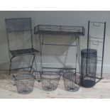 Three two handled black painted wire baskets, a cylindrical umbrella stand, an upright rack, a