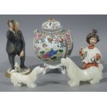 Two onyx models of dogs, two Naples style bisque figures one of an elderly gentleman doffing his