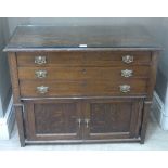 An oak canteen the rectangular top fitted with three felt lined long graduated drawers above a