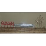 Three coat hooks, one as a pitch fork, a giant comb and a cast 'Queen'; together with a wall shelf