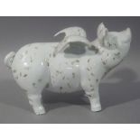 A pottery ornament - flying pig with speckled decoration, 34cm long approximately