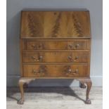 A reproduction mahogany bureau in George III style the fall-flap figured above three conforming