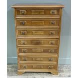 A reproduction mahogany veneered tall chest of seven panelled drawers, 78cm wide