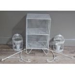 A pair of bird cage style planters in cream, a cream two tier shelf and a pair of cream painted wall