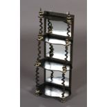 A 19th century ebonised and ivory inlaid set of wall shelves of four graduated tiers, mirror