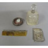 A silver collared cut glass scent bottle, a silver backed comb and a circular silver frame (3)