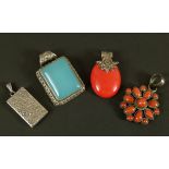 Four silver pendants including a coral set cluster pendant within a circular outline, an oval