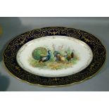 A Dresden porcelain oval meat platter, the centre painted with chickens, cockerel and peacock with