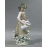 A Lladro porcelain figure of a young girl watering flowers, 29cm high