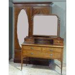 An Edwardian mahogany wardrobe having a moulded cornice, single door with oval inset mirror,