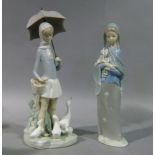 A Lladro figure of a young woman carrying a bunch of Arum lilies, 24cm high; another Lladro figure