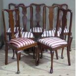 A set of four and set of three mahogany Queen Anne style dining chairs, uniformly upholstered in red