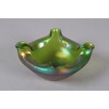 A Loetz style iridescent green square bowl, each side folded inwards, 15.5cm wide