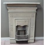 A late 19th century cast iron bedroom fire place with dresser style decoration, cream painted